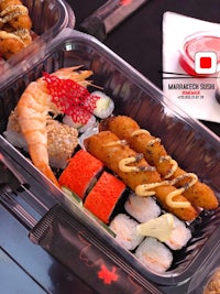 japanese food in plastic containers on a table