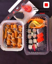 japanese bento box with sushi and vegetables